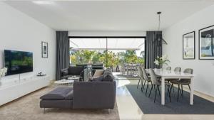 a living room with a couch and a table at Exclusive sea view townhouse with private plunge pool in La Valvega, La Cala de Mijas in La Cala de Mijas