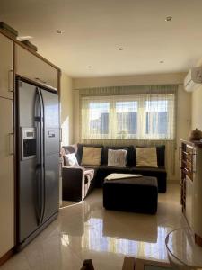 a living room with a couch and a refrigerator at Casa7pias in Ponte de Lima