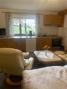 a kitchen with couches and a table in a room at Holzhaus "Miri" in Pirna