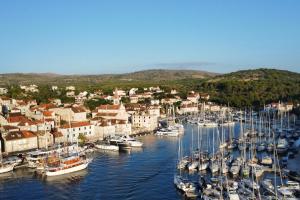 a bunch of boats are docked in a harbor at Luxury Villa Kate on sea with heated pool in Milna