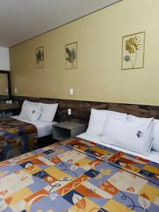 a hotel room with two beds in a room at Hotel Teresita in Puebla