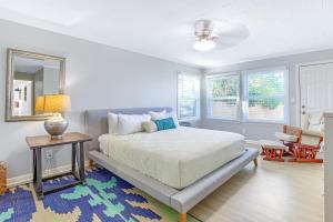 a bedroom with a bed and a table and a mirror at Bay Shore in Panama City Beach