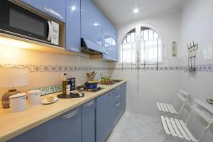 a kitchen with blue cabinets and a sink at Villa MonTLilin - Happy Rentals in Villefranche-sur-Mer