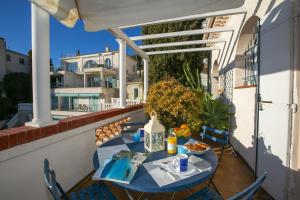 a table and chairs on a balcony with an umbrella at Villa MonTLilin - Happy Rentals in Villefranche-sur-Mer +24 photos