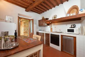 a kitchen with a counter top with a microwave at Casa Citille - Happy Rentals in Greve in Chianti