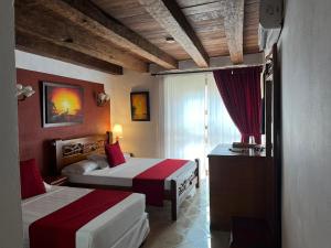 Voodi või voodid majutusasutuse Hotel Don Pedro De Heredia toas