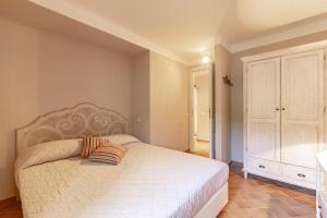 a bedroom with a white bed and a white cabinet at Il Conventaccio Luxury Resort in Ficulle +13 photos
