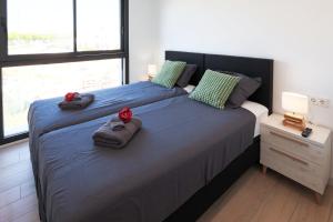 a bedroom with a large bed with towels on it at MADRESELVA 62.29 in Torre-Pacheco +36 photos