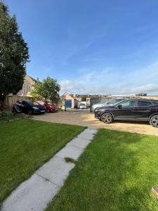 a group of cars parked in a parking lot at ASCENSION BUNGALOW Beautiful spacious 4 bedrooms & free parking in Bath