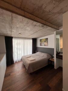 a bedroom with a large bed and a wooden floor at De lo mejor en Barrio General Paz in Cordoba +20 photos