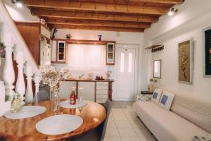 a living room with a wooden table and a couch at Yiannis' Maizonette Ancient Olympia - Happy Rentals in Olympia