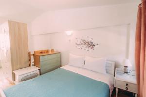 a small bedroom with a bed and a dresser at Yiannis' Maizonette Ancient Olympia - Happy Rentals in Olympia
