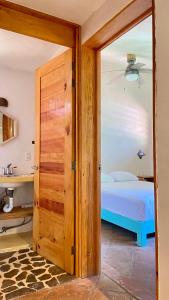 a door leading to a bedroom with a bed at Charming Casa Pacifico with AC, Starlink and Great Location in Mazunte