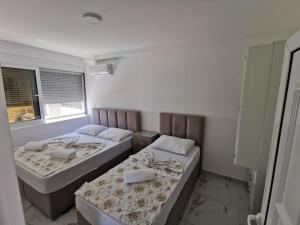 Postel nebo postele na pokoji v ubytování Apartments Bibic