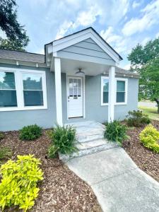 a house with a walkway in front of it at Updated, Fenced, Pet Friendly Downtown Cottage in Southern Pines