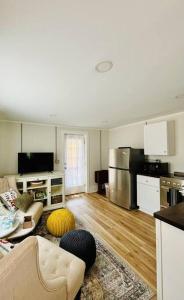 a living room with a couch and a kitchen at Updated, Fenced, Pet Friendly Downtown Cottage in Southern Pines