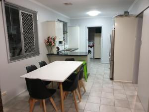 a kitchen and dining room with a table and chairs at Cottage BNB near the hill in Teatree Gully +27 photos