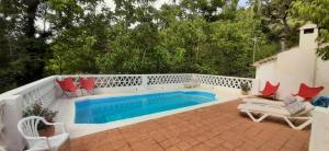 a patio with a pool and chairs and a fence at Molino de Gris Cazorla in Chilluévar
