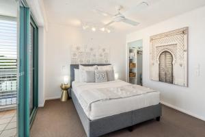 a bedroom with a bed and a ceiling fan at Ocean Front Views with Rooftop Terrace in Caloundra