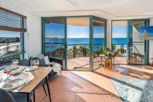 a dining room with a view of the ocean at Ocean Front Views with Rooftop Terrace in Caloundra +16 photos