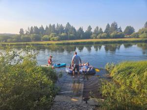 a group of people in kayaks on a river at Beautiful Riverfront Near Mt Bachelor with Hot Tub in Bend +37 photos