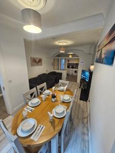 a dining room and living room with a wooden table and chairs at Eyre Square Lane in Galway