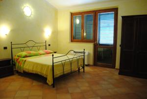 Postel nebo postele na pokoji v ubytování Agriturismo Il Vecchio Carro