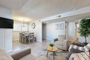 a living room with a couch and a table at Palm Tree Retreat Unit 128 Permit# 4330 in Palm Springs