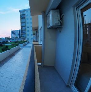 a balcony of a building with a tv on the side at Apartments Eagle, close to center Podgorica, free parking, available transport in Podgorica