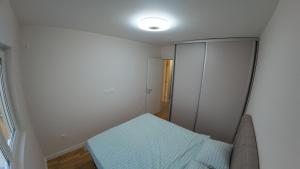 a bedroom with a bed and a cabinet in it at Apartments Eagle, close to center Podgorica, free parking, available transport in Podgorica