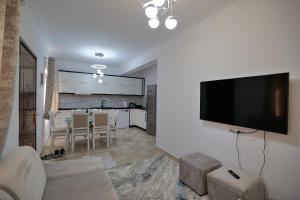 a living room with a flat screen tv on a wall at Loris Apartment in Sarandë