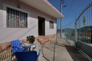 a balcony of a house with blue chairs and a table at Loris Apartment in Sarandë