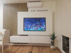 a living room with a tv on the wall at Rest Pedrouzo in O Pedrouzo