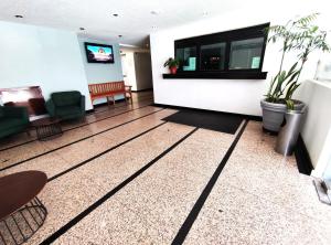 a lobby of a building with plants on the wall at Hotel Habana in Mexico City