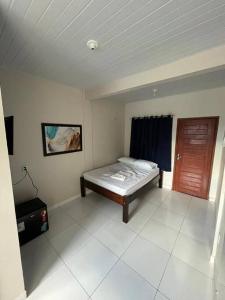a bedroom with a bed in the corner of a room at Temporada BHS Quarto 2 in Barreirinhas
