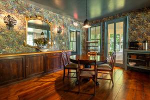 a dining room with a table and a mirror at Wilder House Berkshires in Sheffield