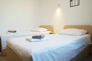 two beds in a room with towels on them at Apartments with parking space Marusici, Omis - 657 in Mimice