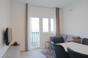 a living room with a couch and a table at Apartments with parking space Marusici, Omis - 657 in Mimice