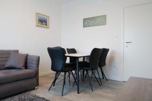 a table and chairs in a living room with a couch at Apartments with parking space Marusici, Omis - 657 in Mimice