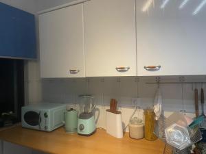 a kitchen counter top with a microwave and a counter top at Home Away from Home in Setúbal