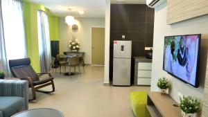 a kitchen and a living room with a refrigerator at Lemon 8 Boutique Hotel @ Melaka in Melaka