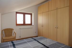 a bedroom with a bed and a window and a chair at Apartments with parking space Senj - 15376 in Senj