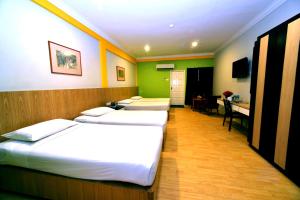 Classic Boutique Hotel Kuantan客房内的一张或多张床位