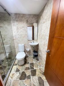 a bathroom with a toilet and a sink at Hotel La Yarolina SAS in Cartagena de Indias