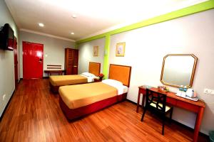 Classic Boutique Hotel Kuantan客房内的一张或多张床位