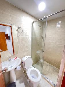 a bathroom with a shower and a toilet and a sink at Hotel La Yarolina SAS in Cartagena de Indias