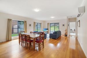 a dining room and living room with a table and chairs at Kurrawa in Port Fairy