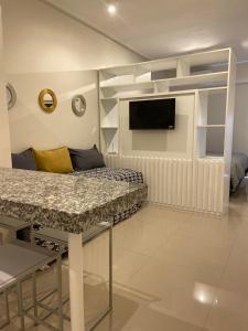a living room with a couch and a tv on a wall at Mirador suite in Yerba Buena +22 photos