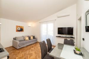 a living room with a couch and a table at Apartments with parking space Privlaka, Zadar - 23472 in Privlaka