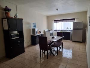 a kitchen with a table and chairs in a room at Departamento Victoria in Saltillo